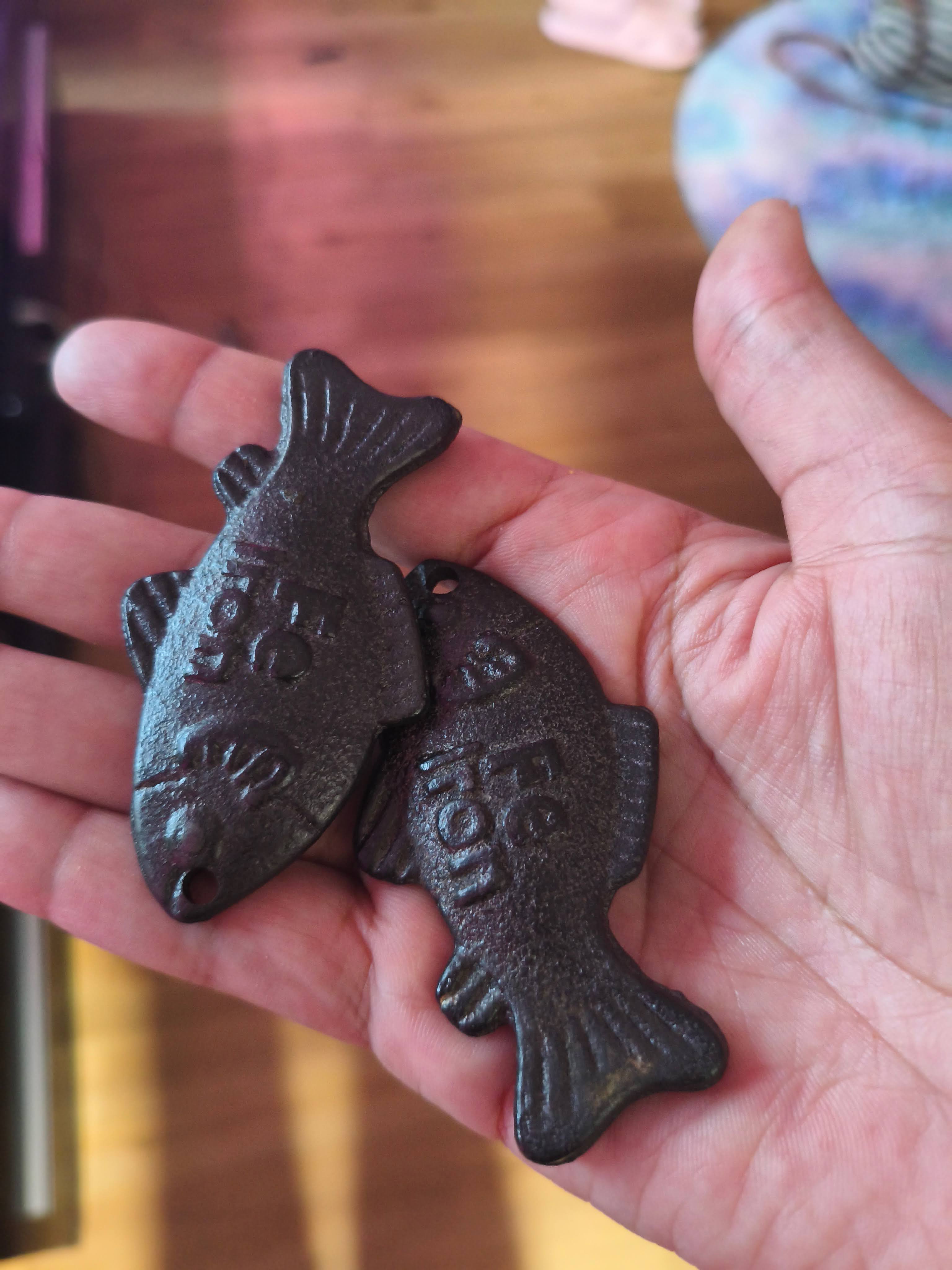 Lucky Iron Fish cast-iron cooking tool resting on a wooden surface